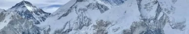 Everest Base Camp during the day with colorful expedition tents at the foot of the Khumbu Icefall and snowy Himalayan peaks